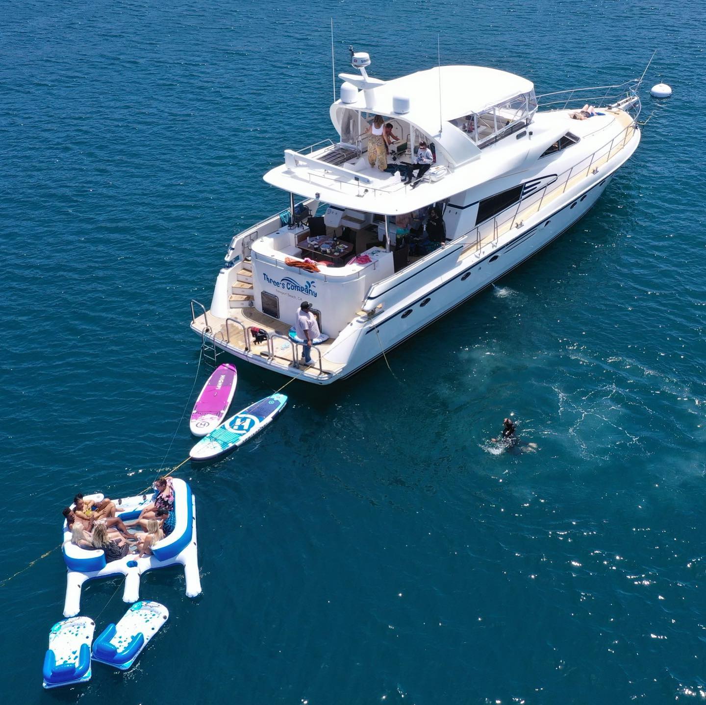 Three's Company 70-foot luxury yacht charter in Marina del Rey with water toys and guests enjoying the ocean
