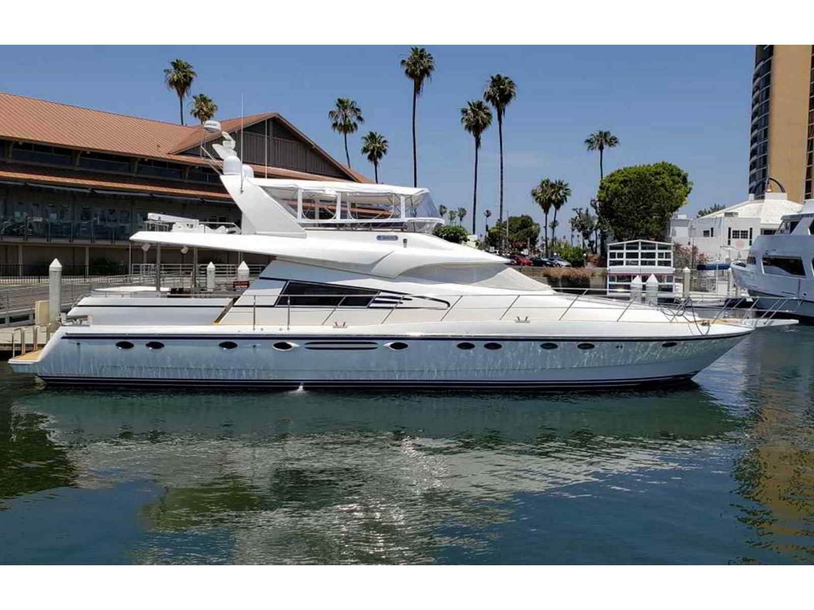 Three's Company 70-foot luxury yacht docked in Marina del Rey, side profile view